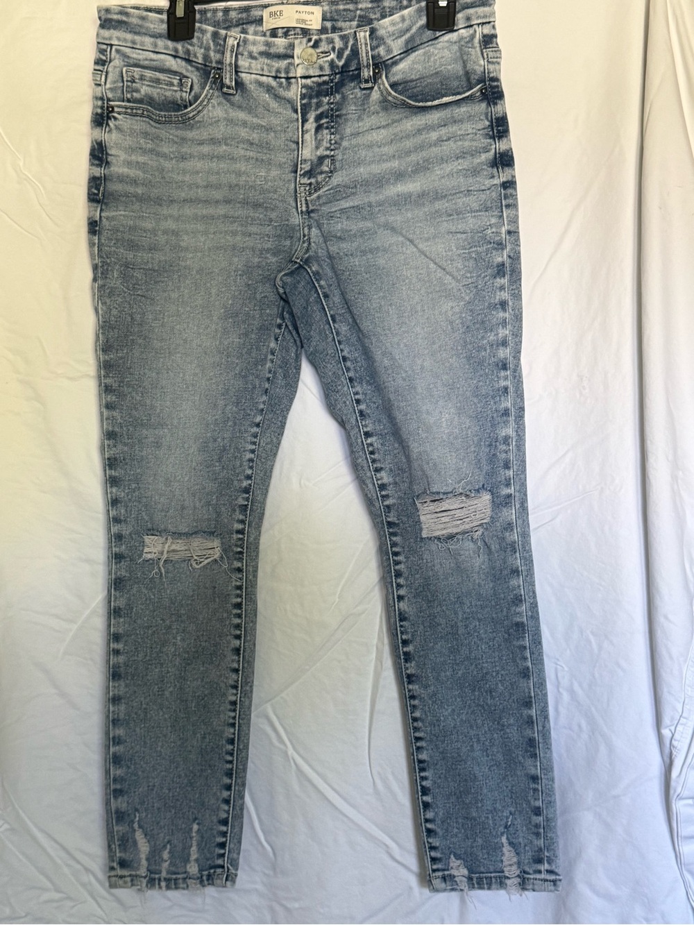 Buckle Light Wash Distressed Skinny Jeans